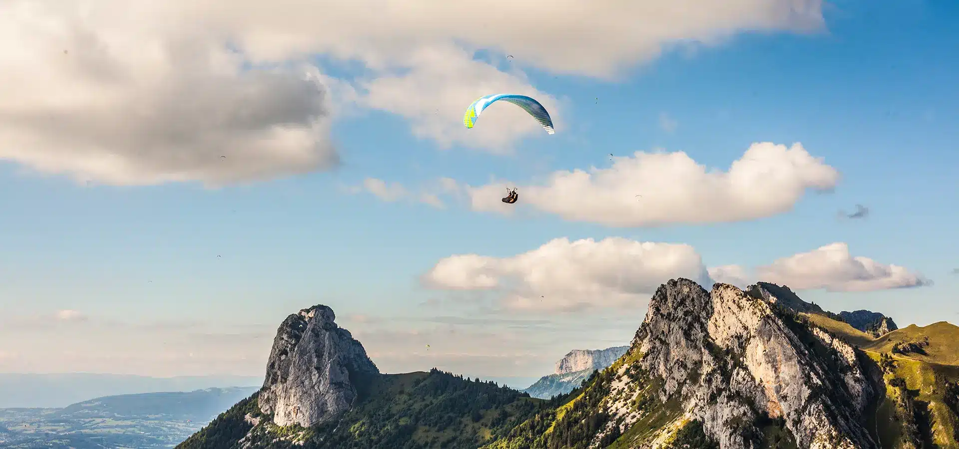Pilote de parapente en stage thermique concentré sur ses sensations dans la sellette et l'écoute de son variomètre.