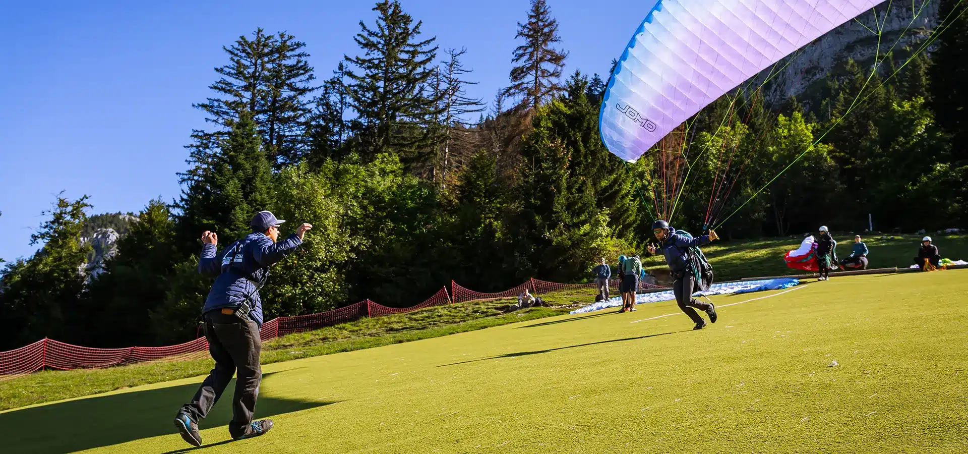 Moniteur Aerodream remettant le passeport de vol libre à un stagiaire après sa semaine d'initiation à Annecy.